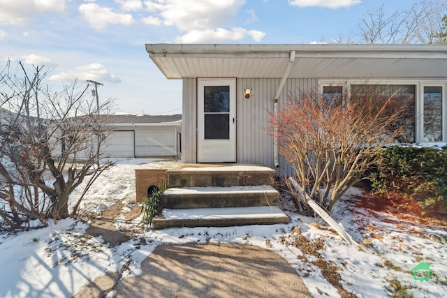 view of snow covered property entrance