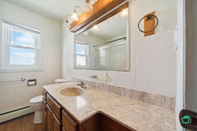 bathroom featuring wood-type flooring, tile walls, a wealth of natural light, and a baseboard radiator