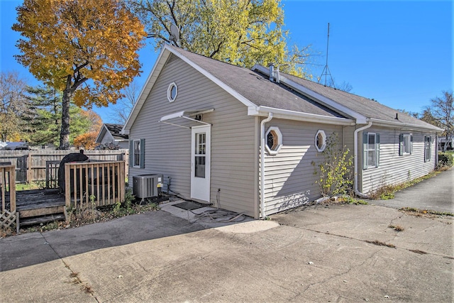 view of side of property with a deck and central AC unit