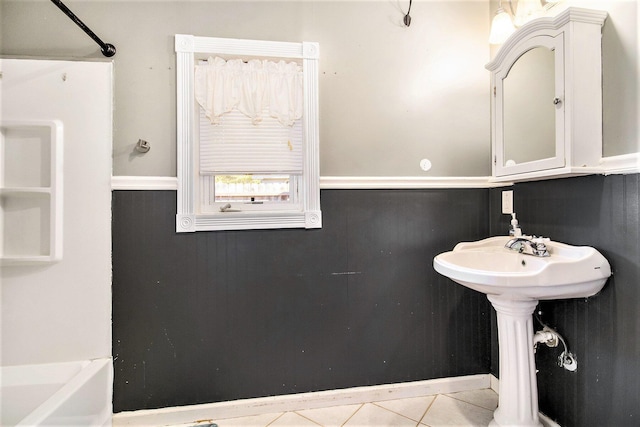 bathroom featuring a bath, tile patterned floors, and sink