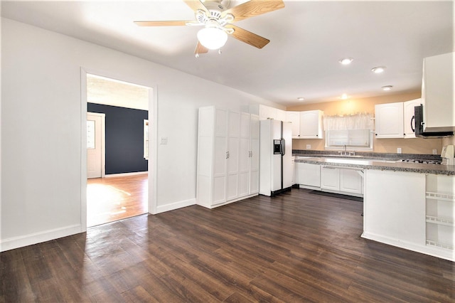 kitchen featuring white refrigerator with ice dispenser, white cabinets, sink, ceiling fan, and dark hardwood / wood-style flooring