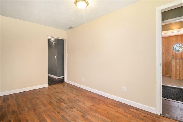 spare room featuring dark wood-type flooring