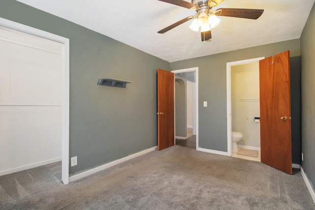 unfurnished bedroom with carpet flooring, ensuite bath, ceiling fan, and a closet