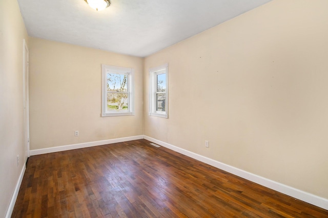 empty room featuring dark hardwood / wood-style flooring