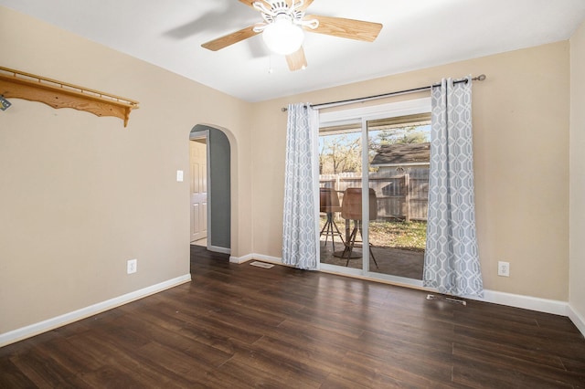 unfurnished room with ceiling fan and dark hardwood / wood-style flooring