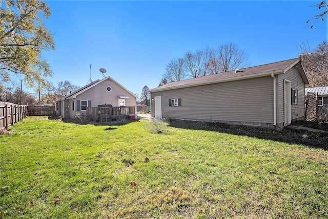 rear view of property with a lawn and a wooden deck