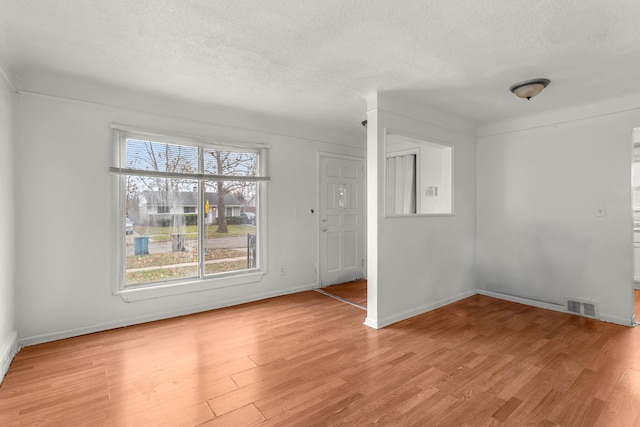 interior space featuring light hardwood / wood-style floors and a textured ceiling