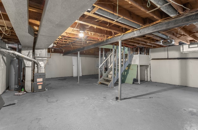 basement featuring heating unit and water heater