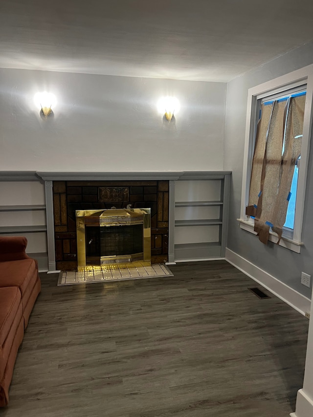 unfurnished living room with a fireplace and dark hardwood / wood-style flooring