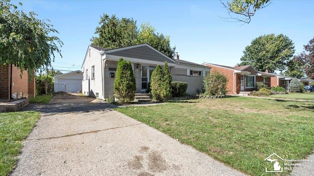 view of front of home featuring an outbuilding, a garage, and a front lawn