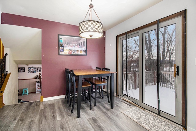 dining space featuring wood-type flooring