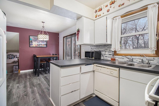 kitchen featuring dishwasher, dark hardwood / wood-style flooring, white cabinetry, and backsplash