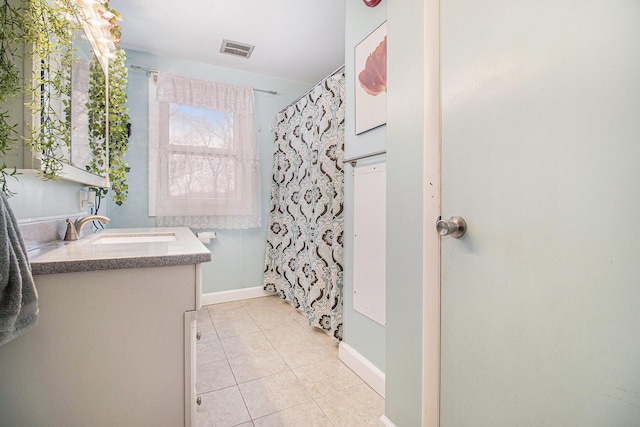 bathroom featuring a shower with curtain, vanity, and tile patterned floors