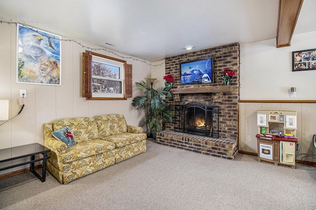 carpeted living room with a fireplace and beamed ceiling