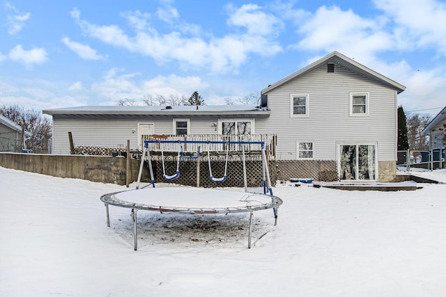 snow covered house with a trampoline