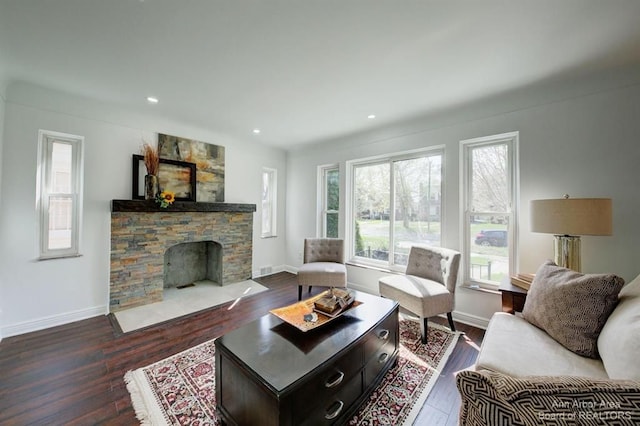 living room featuring dark hardwood / wood-style floors and a fireplace