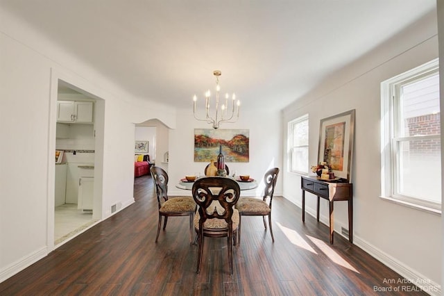 13966 Warwick St, Detroit, MI 48223 - dining area with a chandelier, dark wood-style floors, and arched walkways