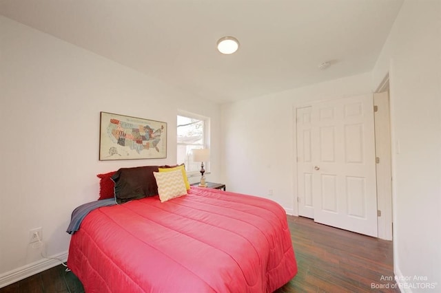 bedroom featuring dark wood-type flooring