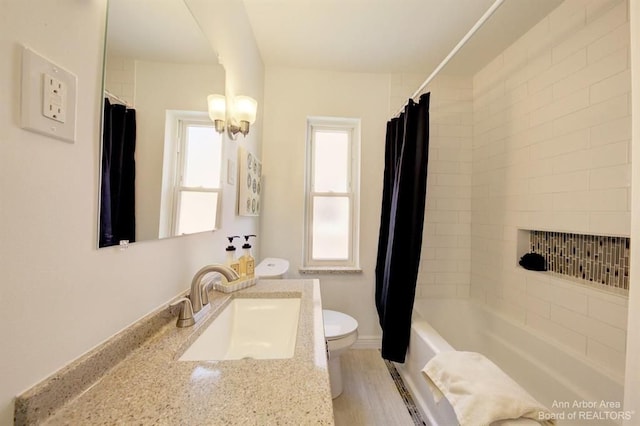 full bathroom with hardwood / wood-style floors, vanity, toilet, and shower / bathtub combination with curtain