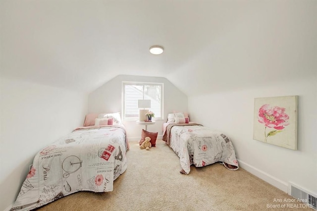 bedroom with carpet and vaulted ceiling