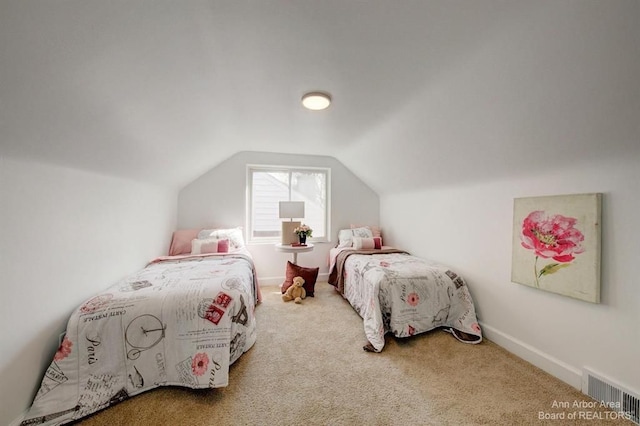 carpeted bedroom with lofted ceiling