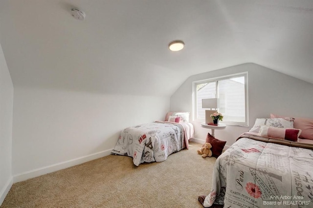 bedroom with carpet flooring and lofted ceiling