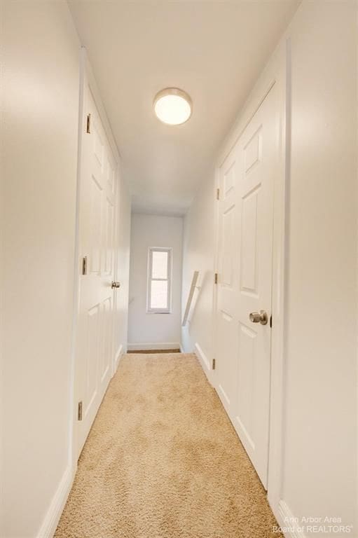 corridor with light colored carpet