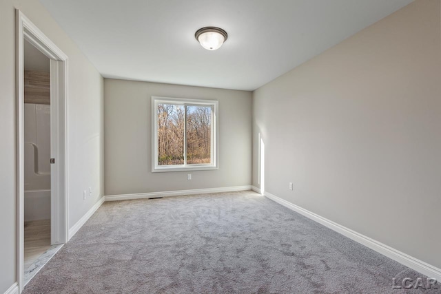 unfurnished room with light carpet