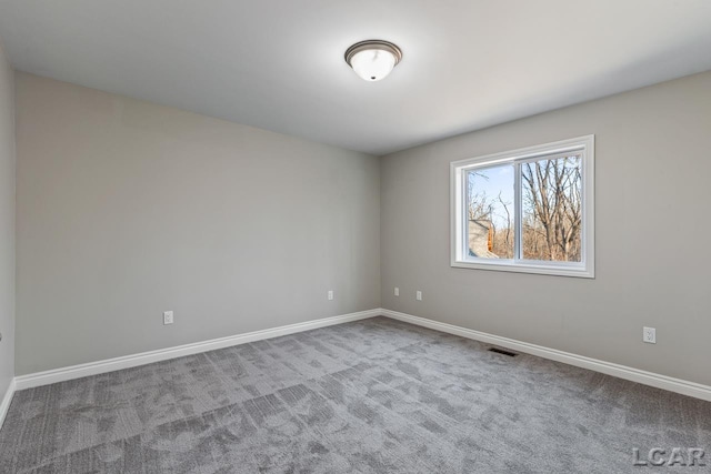 spare room with light colored carpet