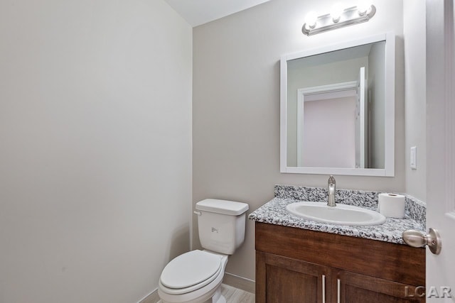 bathroom featuring toilet and vanity