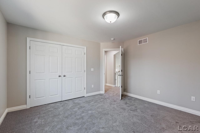 unfurnished bedroom featuring a closet and carpet flooring