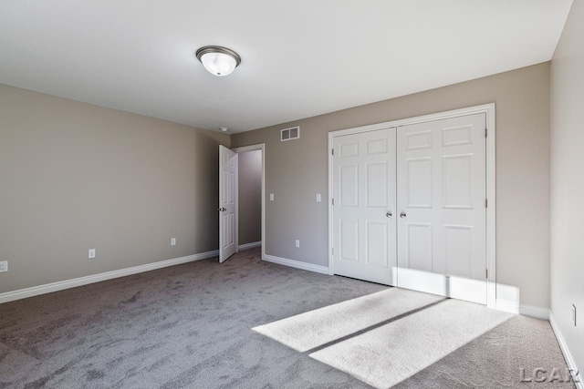 unfurnished bedroom featuring a closet and carpet flooring