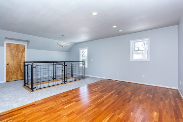 empty room featuring hardwood / wood-style floors and lofted ceiling