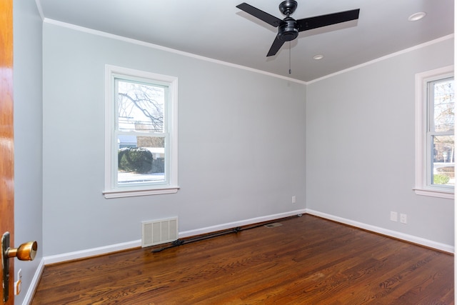 empty room with hardwood / wood-style flooring, ceiling fan, and a healthy amount of sunlight