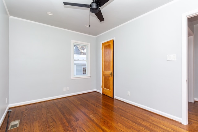 spare room with ceiling fan, dark hardwood / wood-style flooring, and crown molding