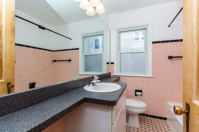 full bathroom with bathtub / shower combination, vanity, tile walls, tile patterned flooring, and toilet