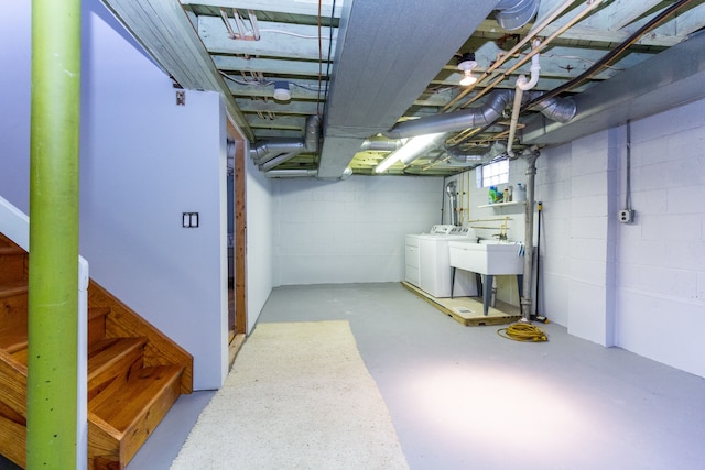 basement featuring independent washer and dryer and sink