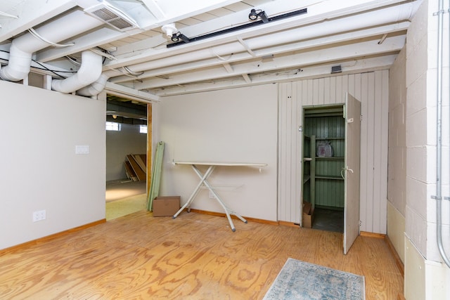 basement featuring light hardwood / wood-style floors