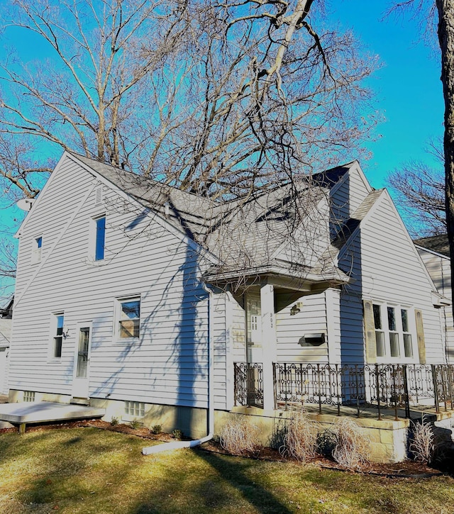 view of property exterior with a lawn