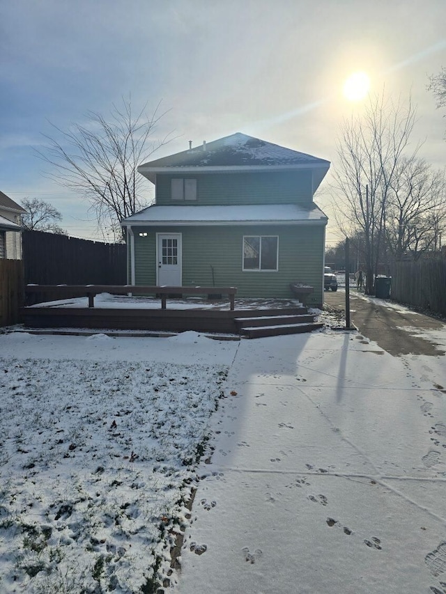 snow covered property featuring a wooden deck