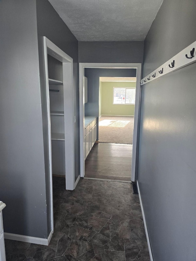 hallway featuring a textured ceiling