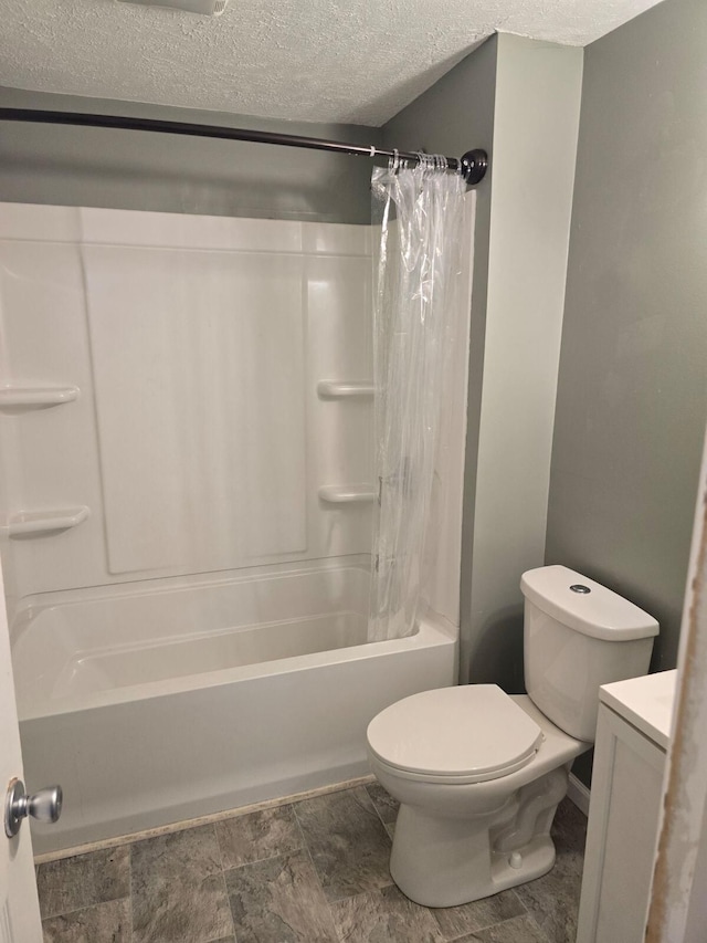 full bathroom with vanity, shower / bath combination with curtain, a textured ceiling, and toilet