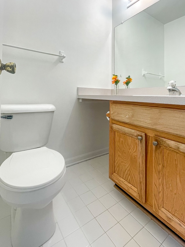 bathroom with vanity, tile patterned floors, and toilet