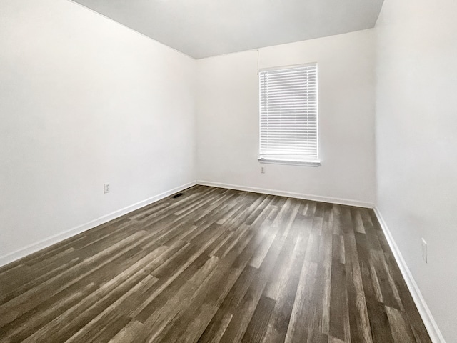 empty room featuring dark hardwood / wood-style flooring