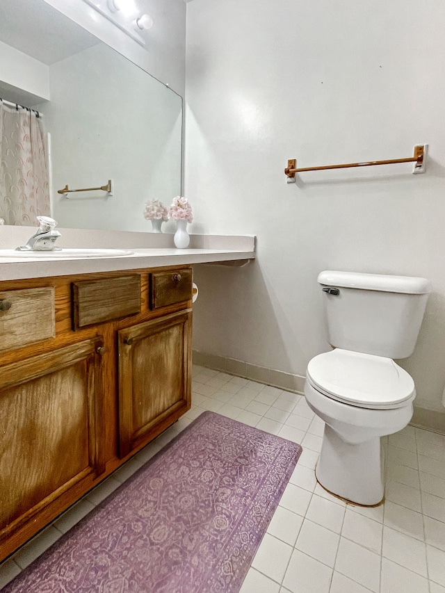 bathroom featuring vanity, toilet, and tile patterned flooring