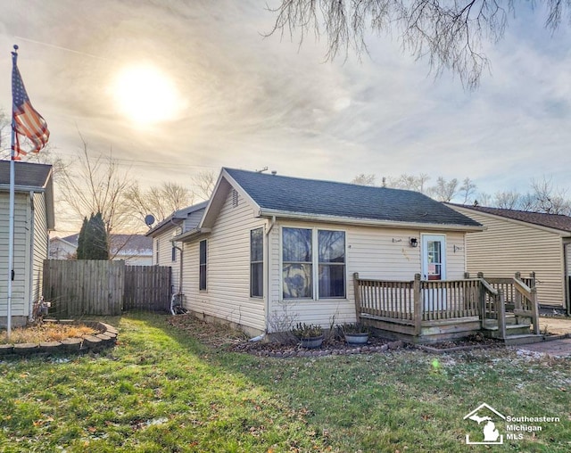 view of front of house with a yard and a wooden deck