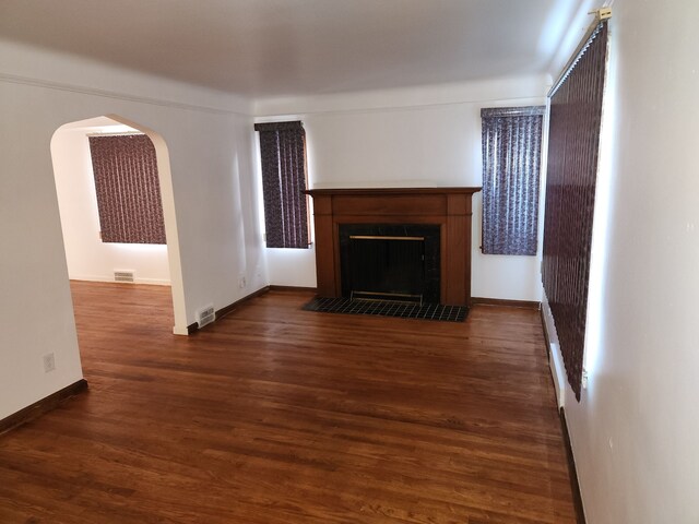 unfurnished living room featuring dark hardwood / wood-style flooring