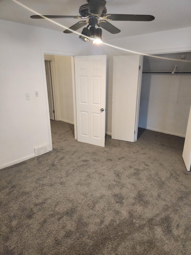 unfurnished bedroom featuring visible vents, a ceiling fan, baseboards, a closet, and dark carpet