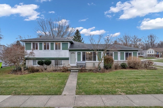 split level home featuring a front lawn