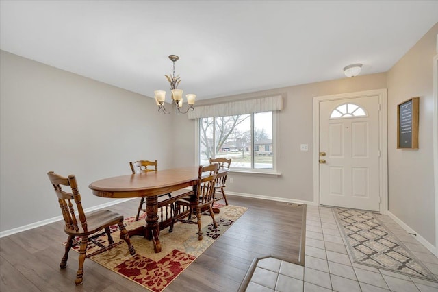 dining area featuring light hardwood / wood-style floors and a notable chandelier